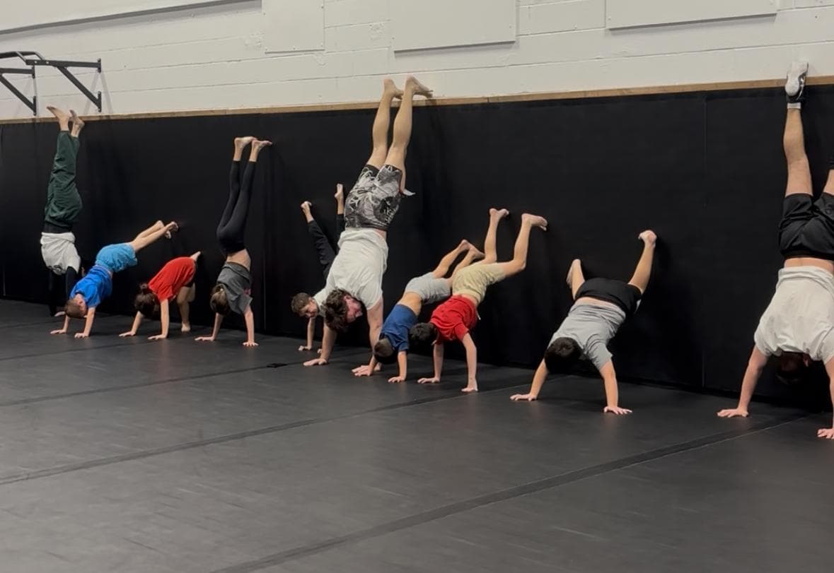 Children developing balance and coordination with handstand drills