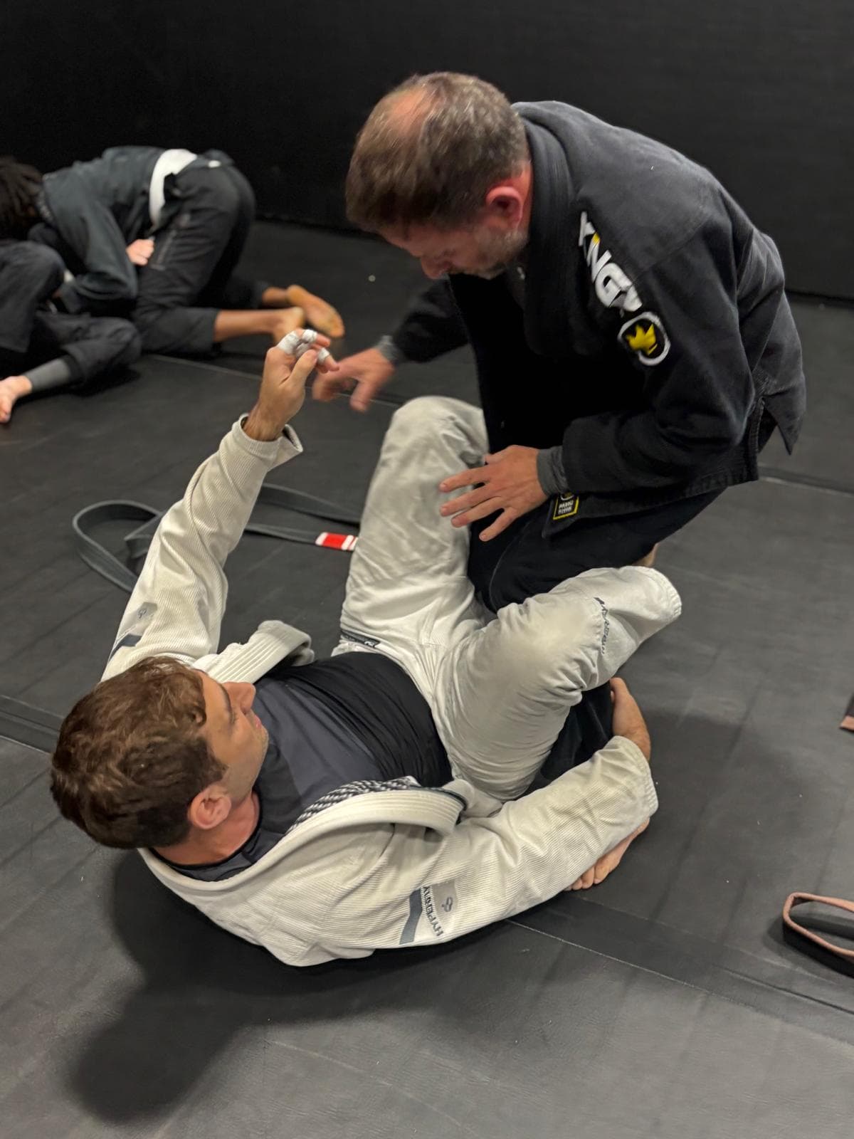 Adult gi students practising guard control at United Grappling Club
